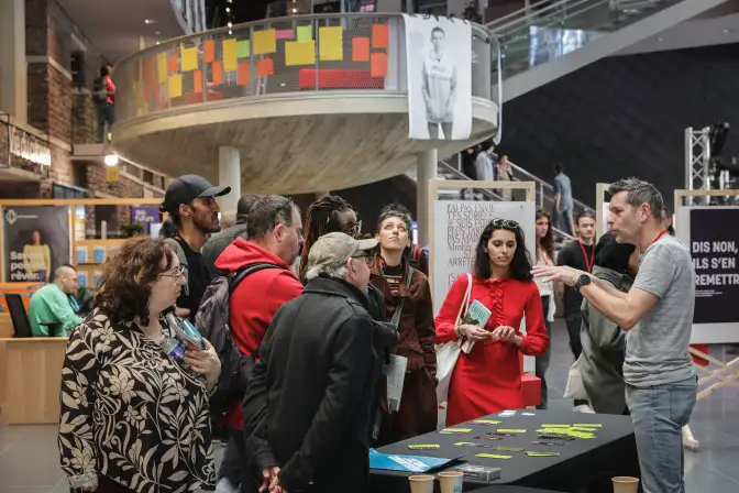 Dans le hall des Champs Libres, un stand dédié à la question du consentement est installé, devant lequel se tiennent une dizaine de personnes.